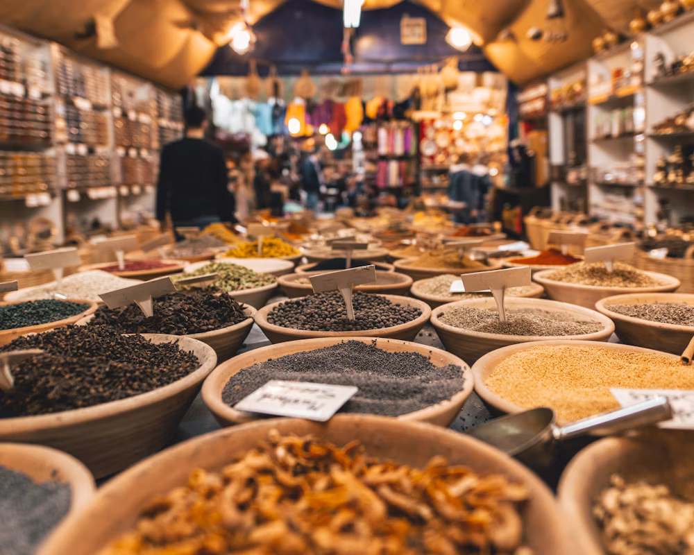 A traditional market with large vessels of grains and spices