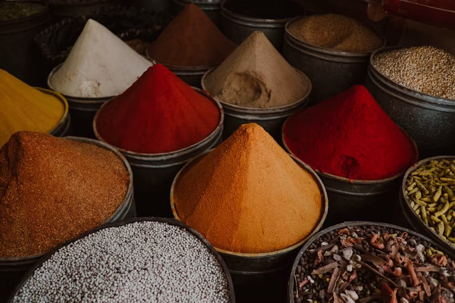 Bowls of colourful ground spices arranged side by side